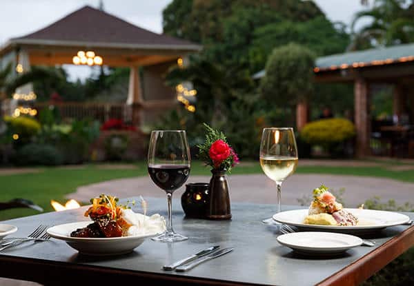 a plate of food and a glass of wine